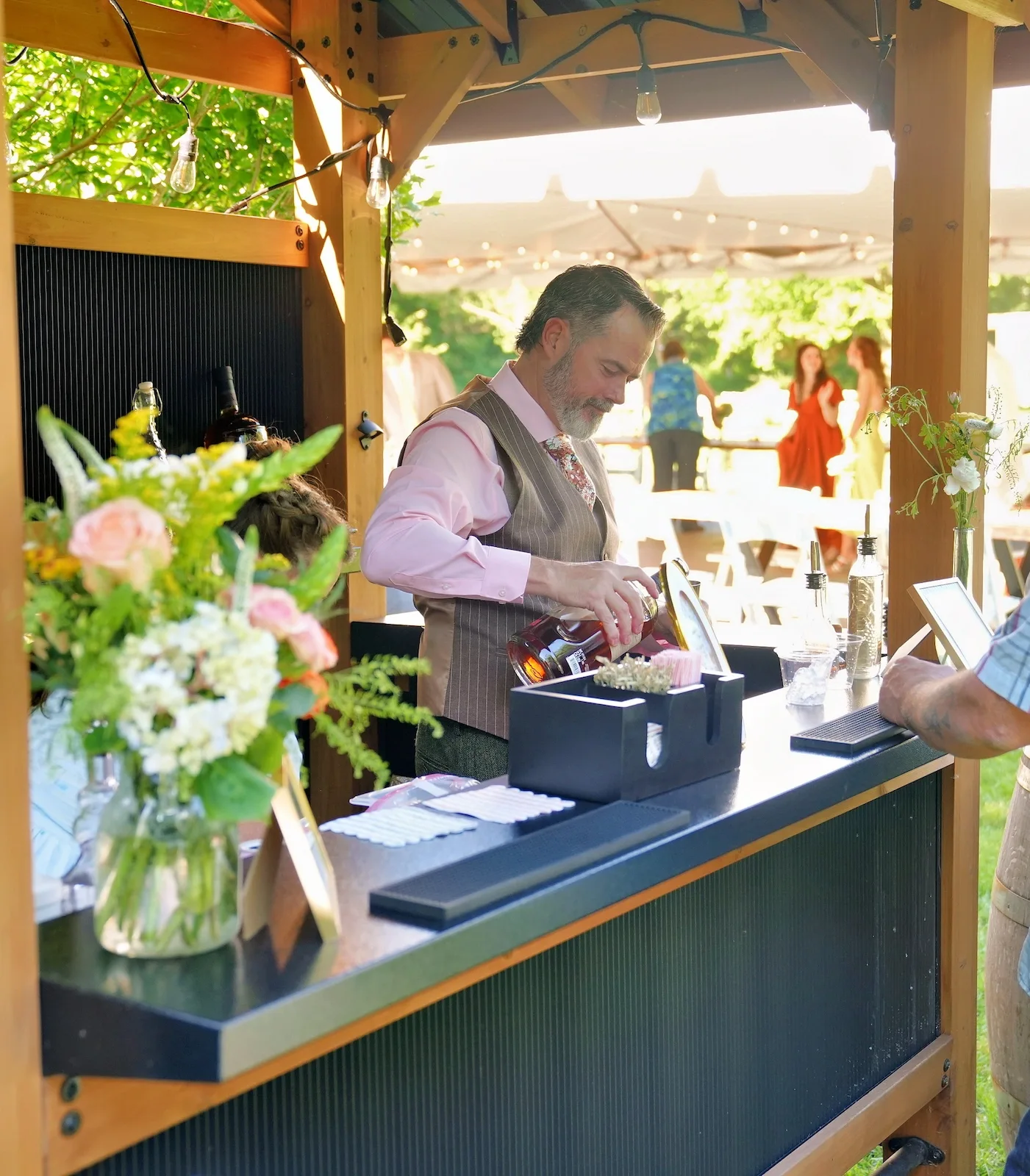 Bartender pouring a signature cocktail at a Spokane wedding