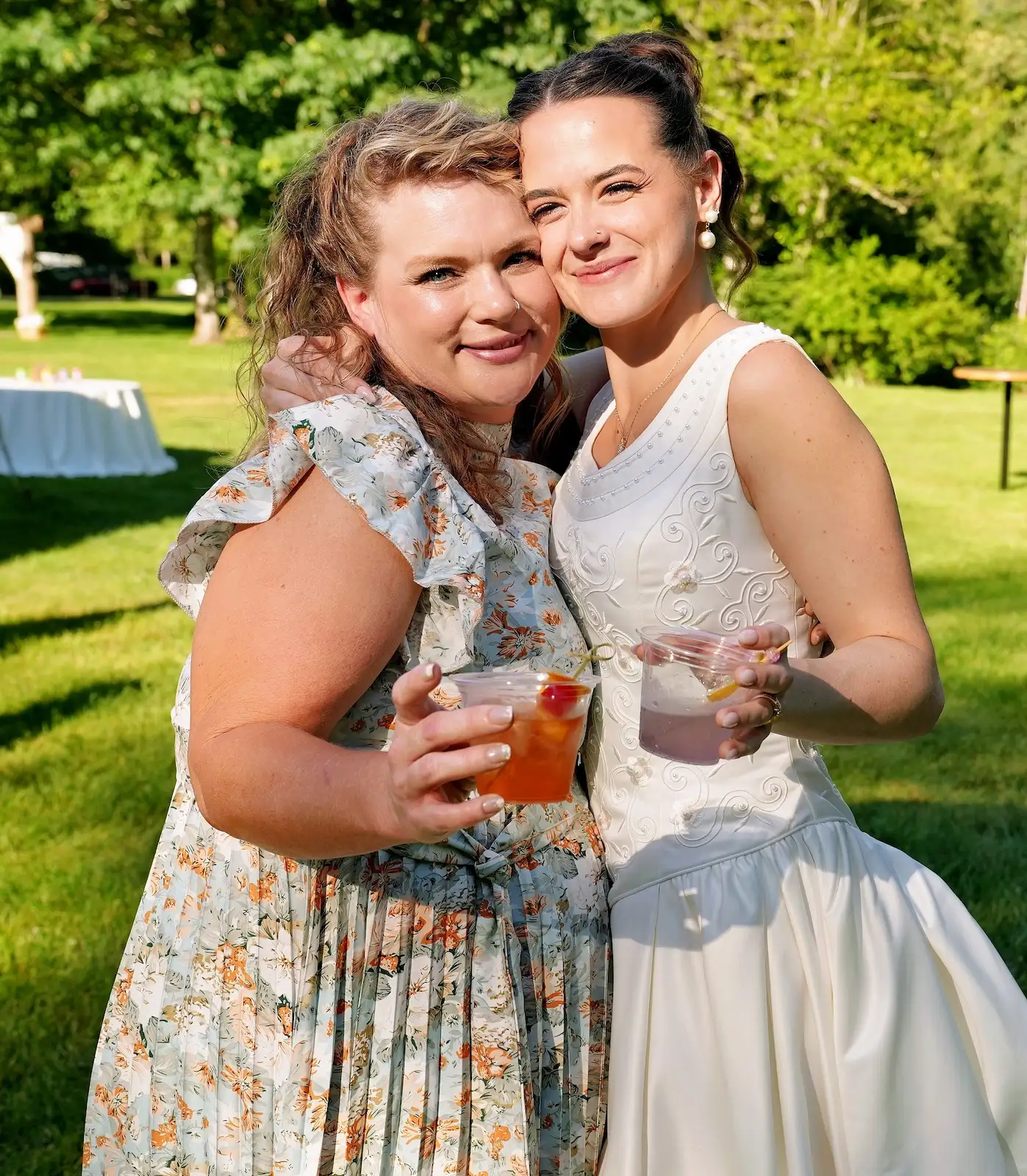 Bride and guest toasting with cocktails