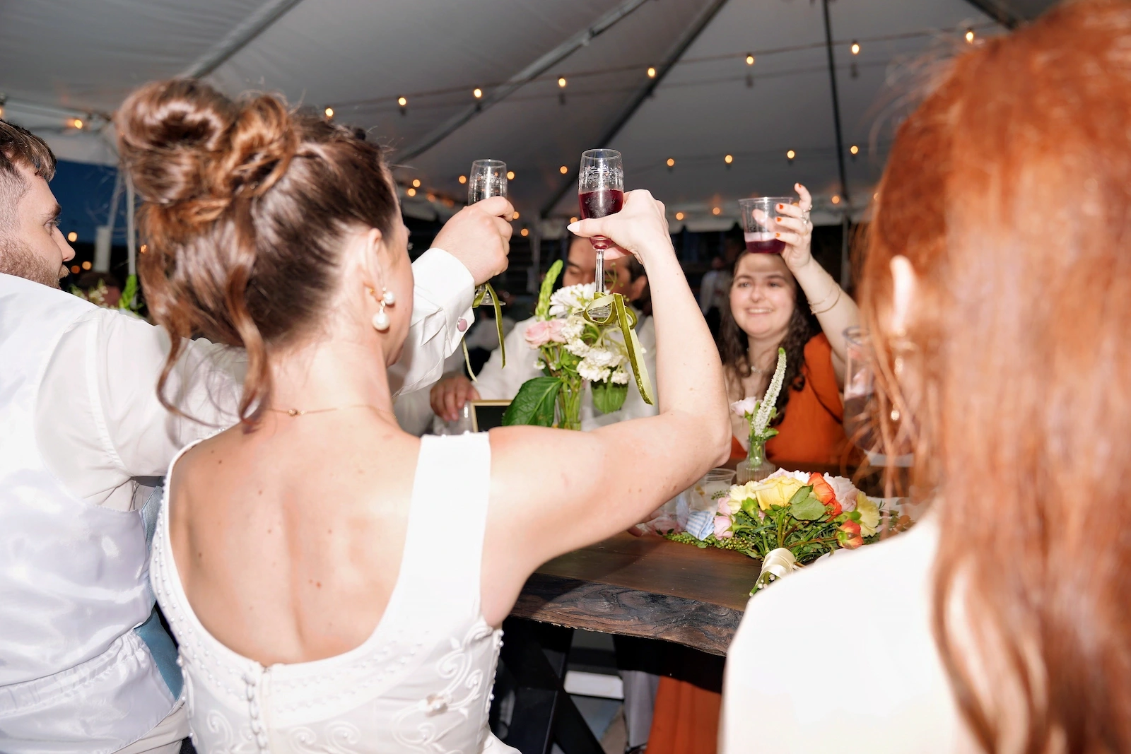 Wedding toast under string lights at a Spokane reception